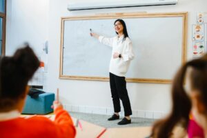 a woman teaching in front of the class